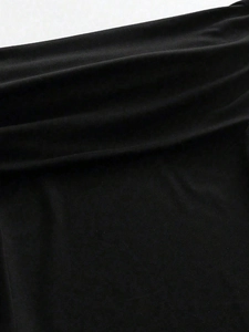 Detail shot of black knitted fabric texture with soft natural drapes and high-quality finish