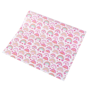 Detail of gift wrapping paper featuring hand-drawn rainbows and love patterns