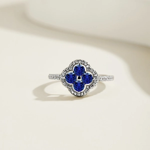 Detailed macro of S925 silver ring featuring blue clover petals and pavé zircon stones