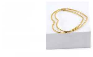 Detailed view of large gold heart-shaped hoop earrings in polished stainless steel