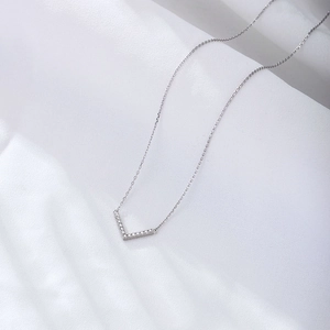 Elegant 925 sterling silver V-shaped necklace with shimmering pavé diamond pendant on white silk