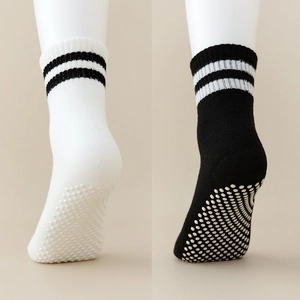 Detail showing non-slip silicone grippers on the sole of striped cotton mesh baby socks