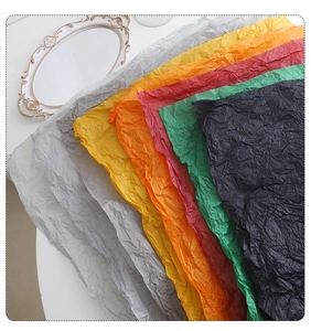 Detailed view of colorful wrinkled tissue paper stack for bouquet and gift packaging