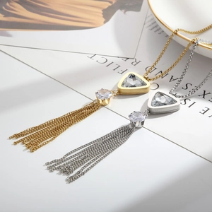 Detail shot of long tassel necklaces with geometric triangle pendants and sparkling crystals
