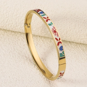 Macro shot of 18K gold plated steel bangle with colorful floral enamel details