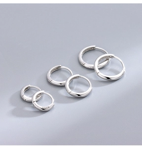 Detailed view of three sizes of S925 sterling silver hoop earrings with hallmark stamps