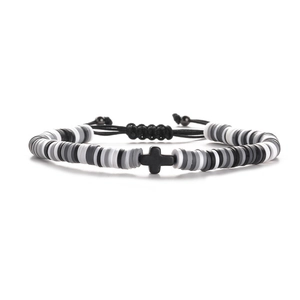 Detailed view of 6mm heishi bead bracelet with cross charm and adjustable cord