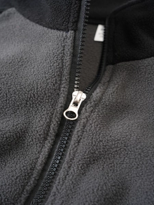 Detail of high-density zipper and fleece fabric on men's tactical outdoor jacket