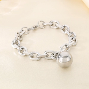Close-up of a polished silver stainless steel bracelet with a hollow sphere and lobster clasp