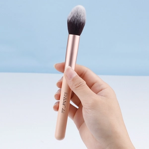 Peach pink powder brush with rose gold ferrule and dual-tone soft bristles by Rancai