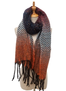 Detailed view of winter knitted shawl with color gradient blue orange and tassel fringe