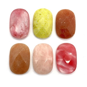 Detailed view of six oval faceted gemstones in natural agate and tiger eye for DIY jewelry