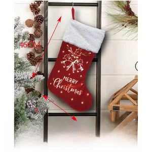 Close-up of red Christmas stocking with white faux fur trim and gold Merry Christmas text