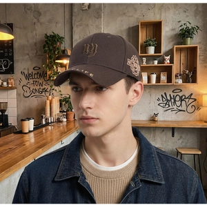 Detail of dark brown baseball cap featuring 3D NY embroidery and MY LIFE brim text