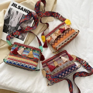 Detail shot of bohemian canvas tote bags with ethnic elephant embroidery and tassels