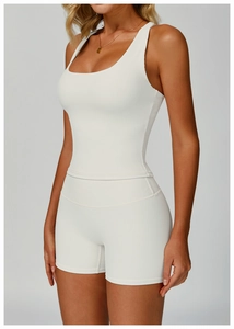 Detail of white ribbed yoga set featuring a tight crop top and high waist shorts