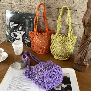 Detail of colorful hand-woven cotton rope bucket bags in vibrant orange, lime, and purple