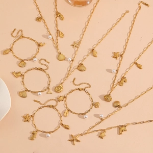 Golden titanium steel jewelry set with seashell starfish and pearl charms on paperclip chain