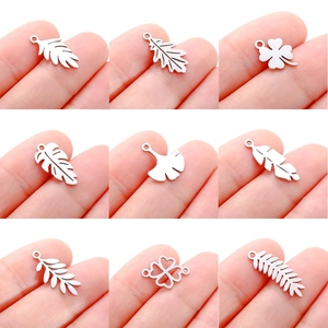 Detailed close-up of nine stainless steel leaf pendants for DIY jewelry making