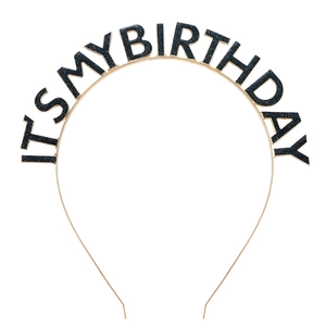 Close-up of golden metal birthday headband with black glitter IT'S MY BIRTHDAY text