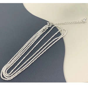 Detailed macro of 925 silver shimmering woven chain with spring clasp and extension