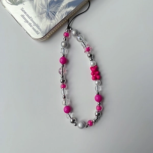 Detail of pink bear charm and silver star beads on a stylish handmade phone strap