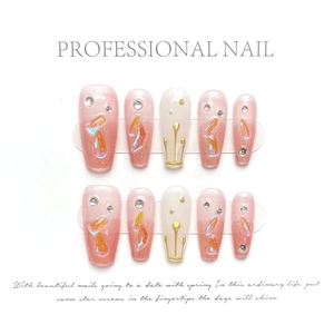 Close-up of handmade press-on nails with pink gradients, crystals and golden lines