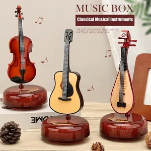 Vintage instrument music boxes featuring violin and guitar with wooden texture base