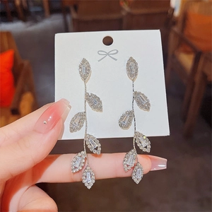 Detailed view of silver long leaf tassel earrings with sparkling 925 silver needles