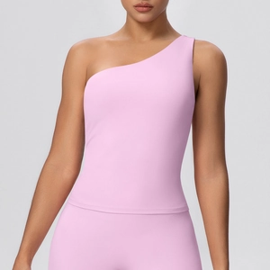 Detail view of pink one-shoulder yoga vest with moisture-wicking fabric on model
