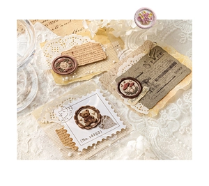 Close-up of 3D embossed vintage sealing stickers with retro letter and floral motifs