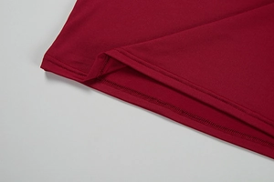Detail shot of wine red knit dress hemline showing professional double-needle stitching