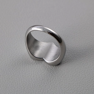 Polished heart-shaped stainless steel ring with a smooth mirror finish and inner brushed texture