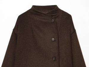 Close-up of deep brown soft jacket showing stand collar and dark brown button details