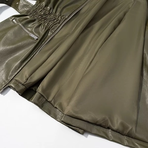 Olive green PU leather jacket featuring a zipper closure and smooth inner lining detail