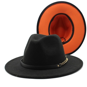 Two-tone wool fedora hat in black and orange with a bold gold chain and leather band