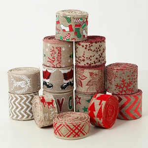 Rolls of linen-style Christmas ribbons with festive patterns like snowflakes and reindeer