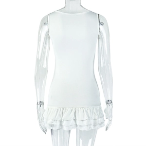 Back view of a white sleeveless mini dress with tiered pleated ruffles on the skirt