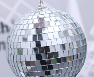 Close-up of a silver disco ball featuring square glass mirrors and a metal hanging hook