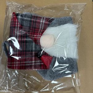 Close-up of a Christmas gnome stocking in red plaid hat and grey felt with long white beard