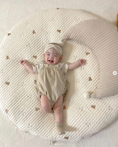 Close-up of quilted cotton moon nursing pillow featuring cute bear embroidery detail