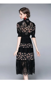 Detailed back view of a black lace patchwork midi dress with elegant floral and dot patterns
