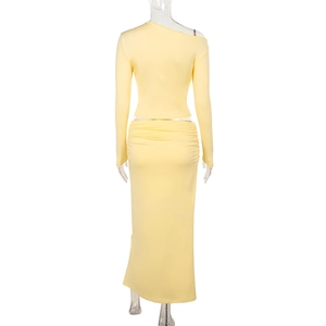 Back view of yellow two-piece knit set featuring fitted skirt with side pleats