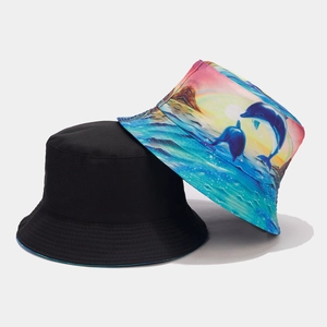 Reversible bucket hat featuring black solid color and colorful dolphin sunset graffiti print