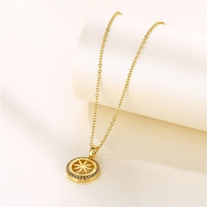 Gold starburst pendant necklace with micro-pave cubic zirconia on a minimalist base
