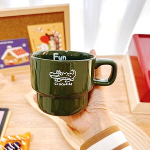 Green stackable ceramic coffee mug with cute crocodile pattern and handle for office