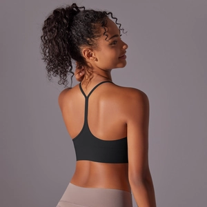 Detail view of the black Y-back sports bra featuring thin straps and breathable fabric