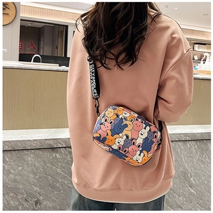 Detail of cartoon rabbit print crossbody bag with wide adjustable branded strap