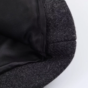 Detailed macro view of dark grey wool fabric and black high-density twill lining texture
