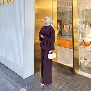 Detail of plum purple loose shirt and wide-leg trousers set in a modest elegant style